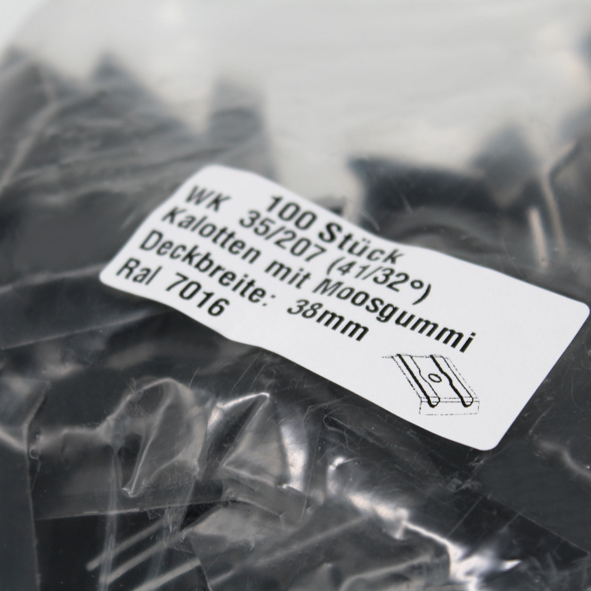 Verpackung mit Kalotten in Anthrazitgrau. Auf dem Aufkleber steht der Inhalt und technische Daten.